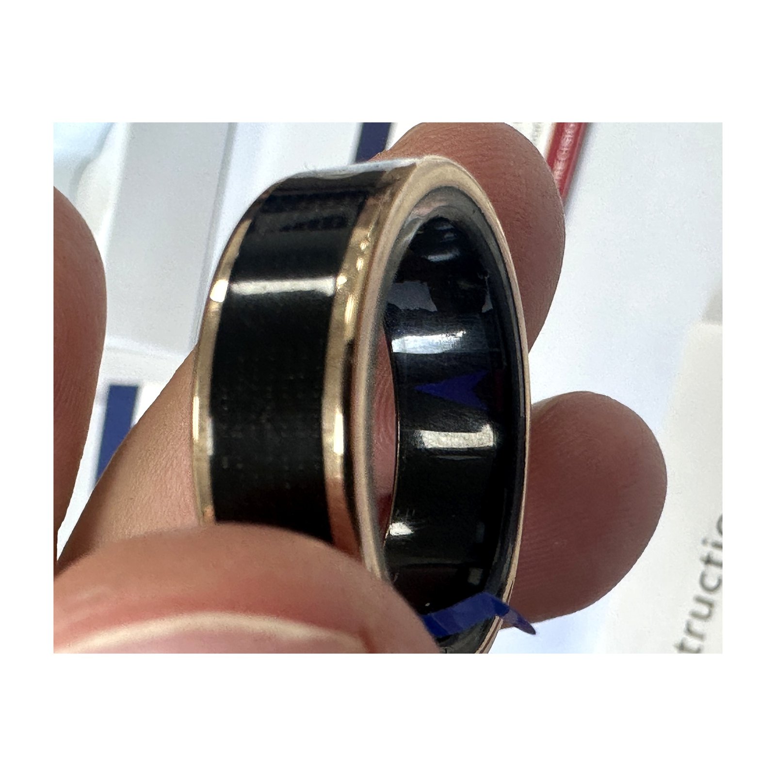 Close-up macro of the SR16 smart ring showing sensors and epoxy potting detail